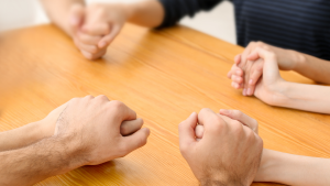 Holding hands across a table | NICRC